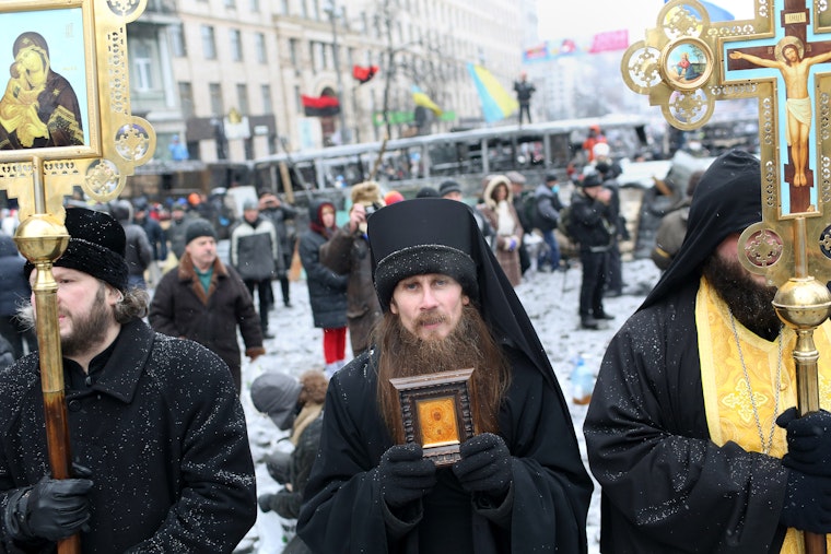 The debate over the extent of the involvement of the Ukrainian far-right in the Maidan movement, the Revolution of Dignity and its aftermath is examined in this report. Here, priests from the Ukrainian Orthodox Church stand and pray between demonstrators and police forces during a lull in violent clashes in central Kiev on Hrushevsky Street in January 2014. Photo credit: © Joseph Sywenkyj/Redux Priests holding religious objects standing
