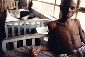 A tuberculosis patient and prisoner lies chained to his bed at Homa Bay Hospital on the shores of Lake Victoria, Kenya, on December 16, 2000. Photo credit: © Lori Waselchuk/AP Man handcuffed to a hospital bed