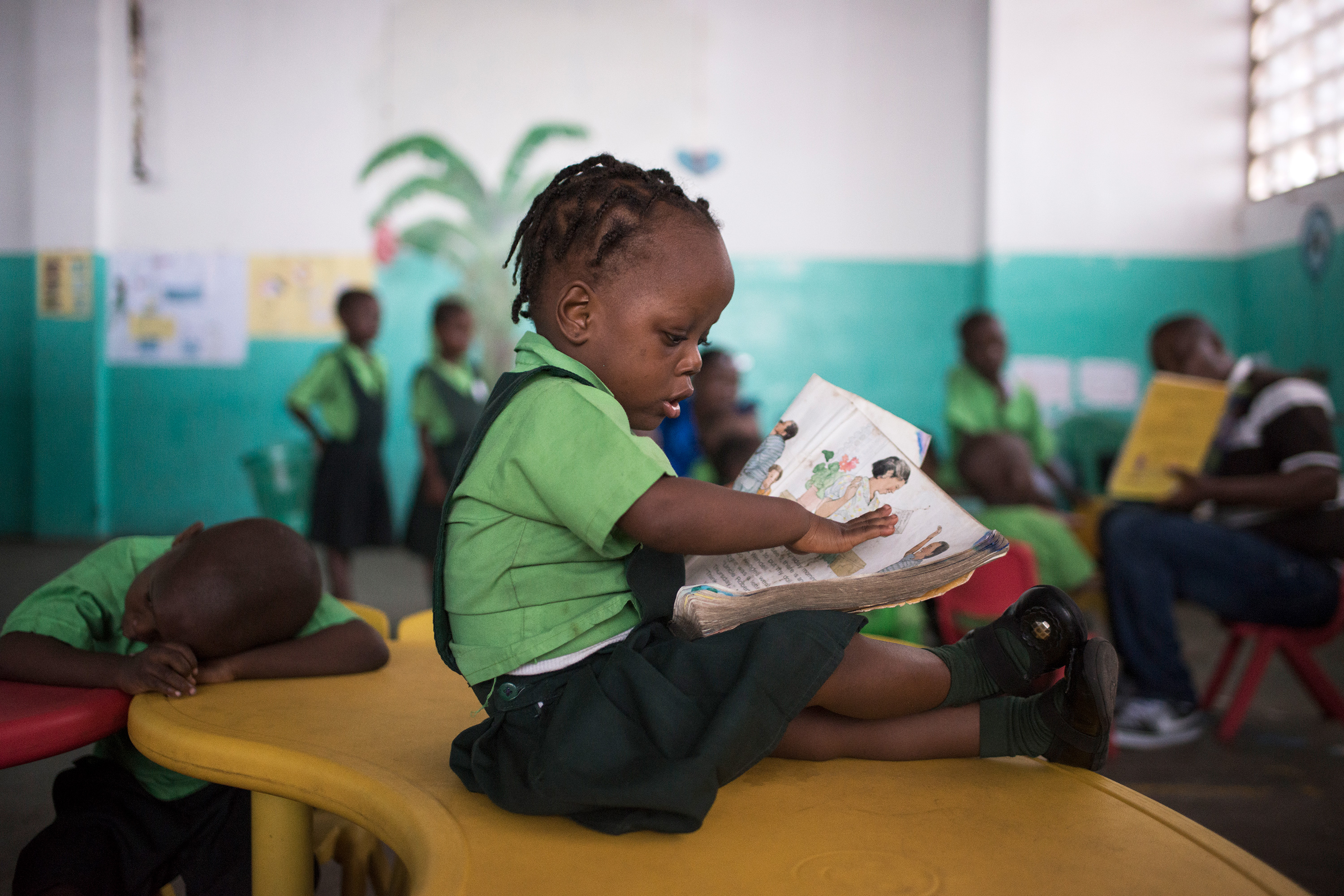 A young girl looking at a book