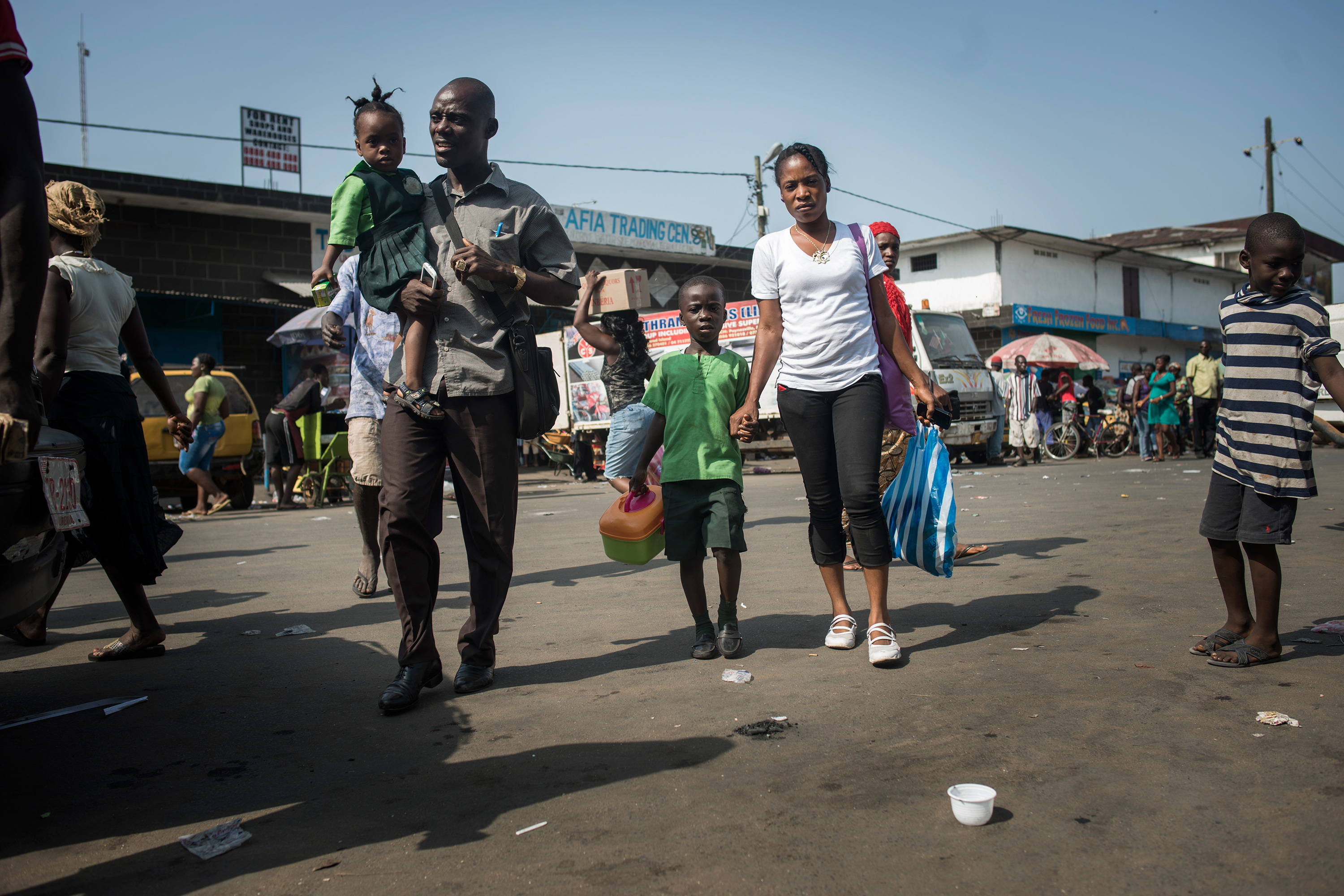 A family crossing a street together